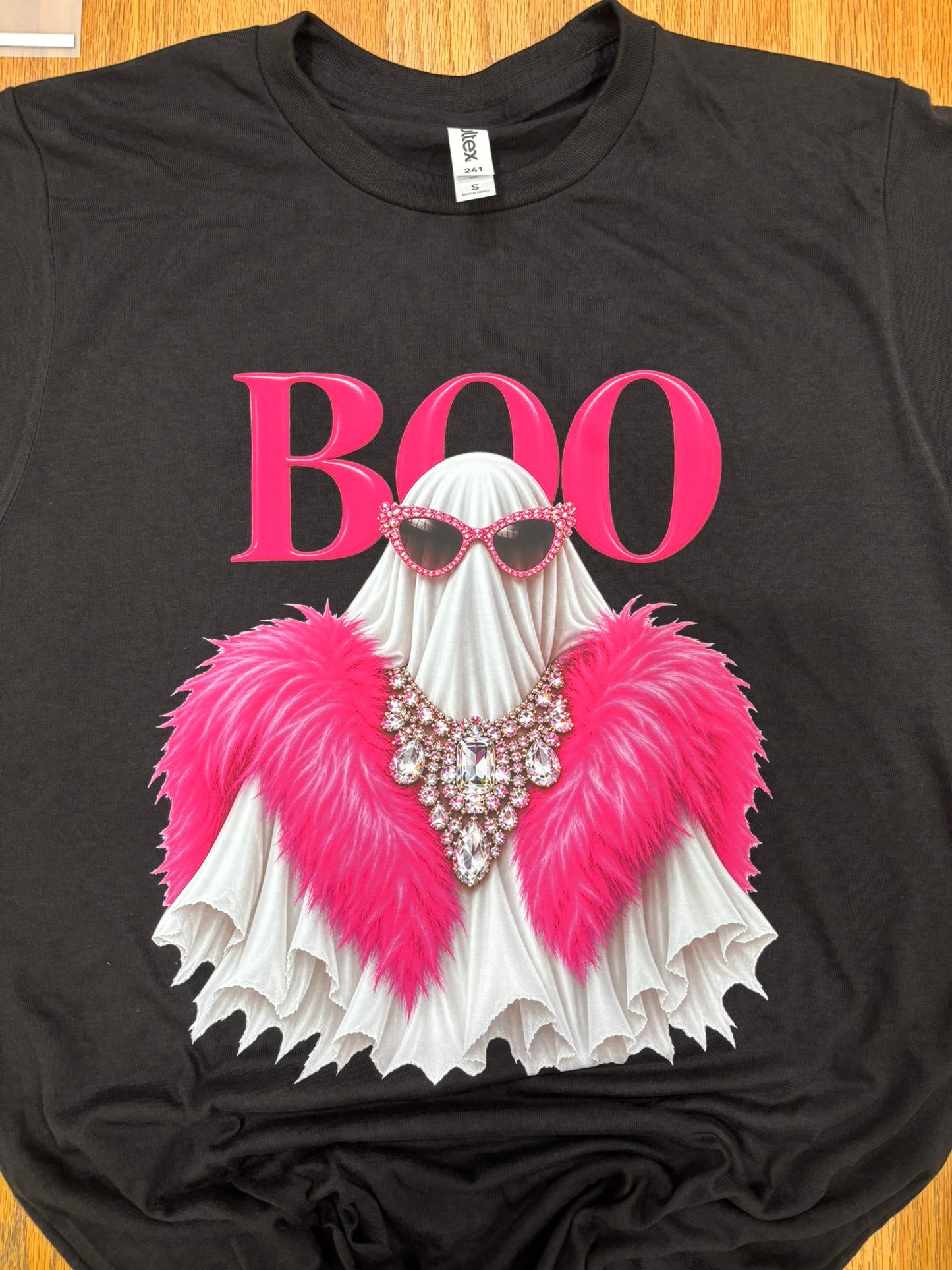 Boo Ghost wearing pink boa on black shirt