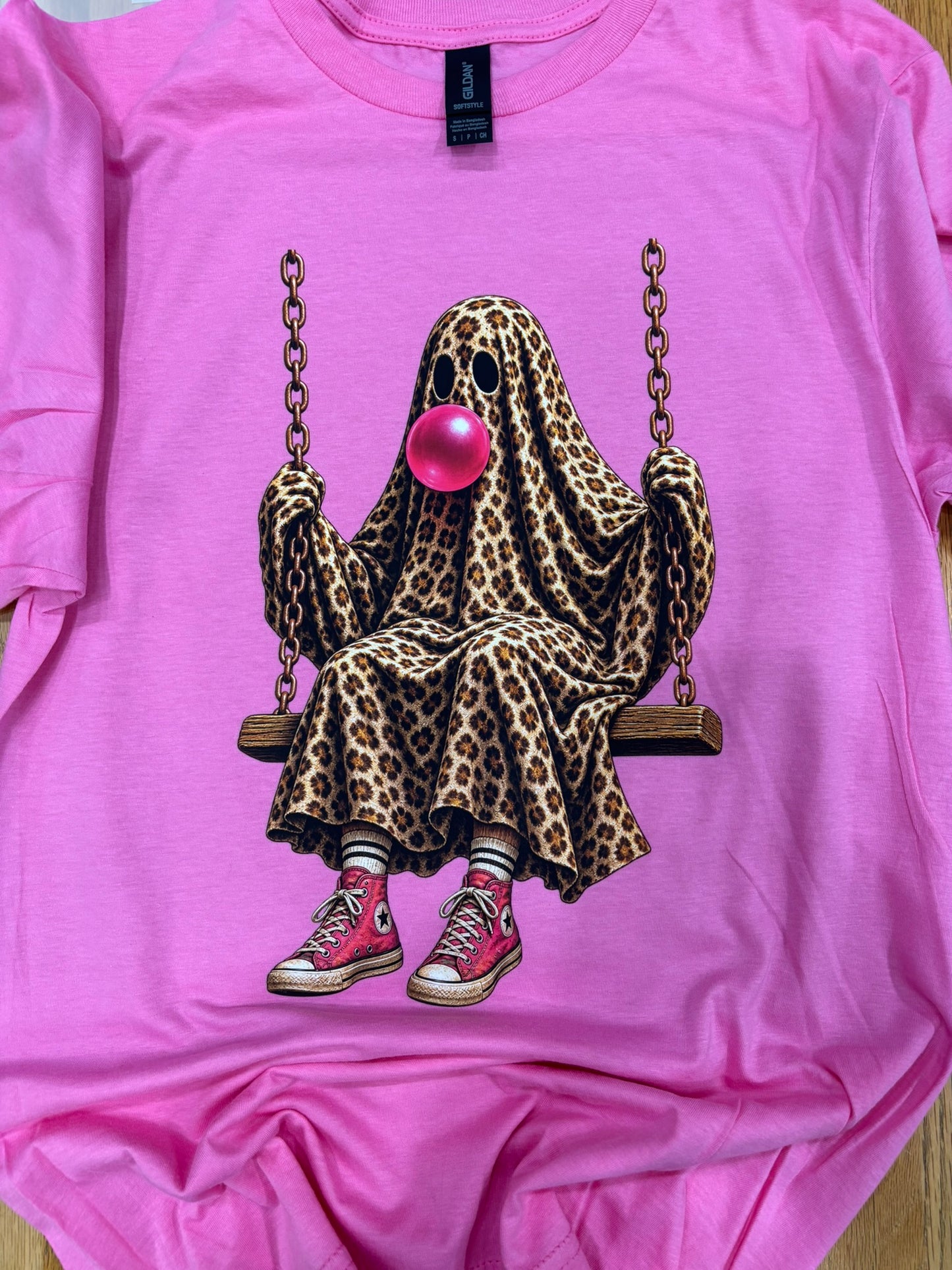 Cheetah ghost blowing bubble on swing on pink shirt